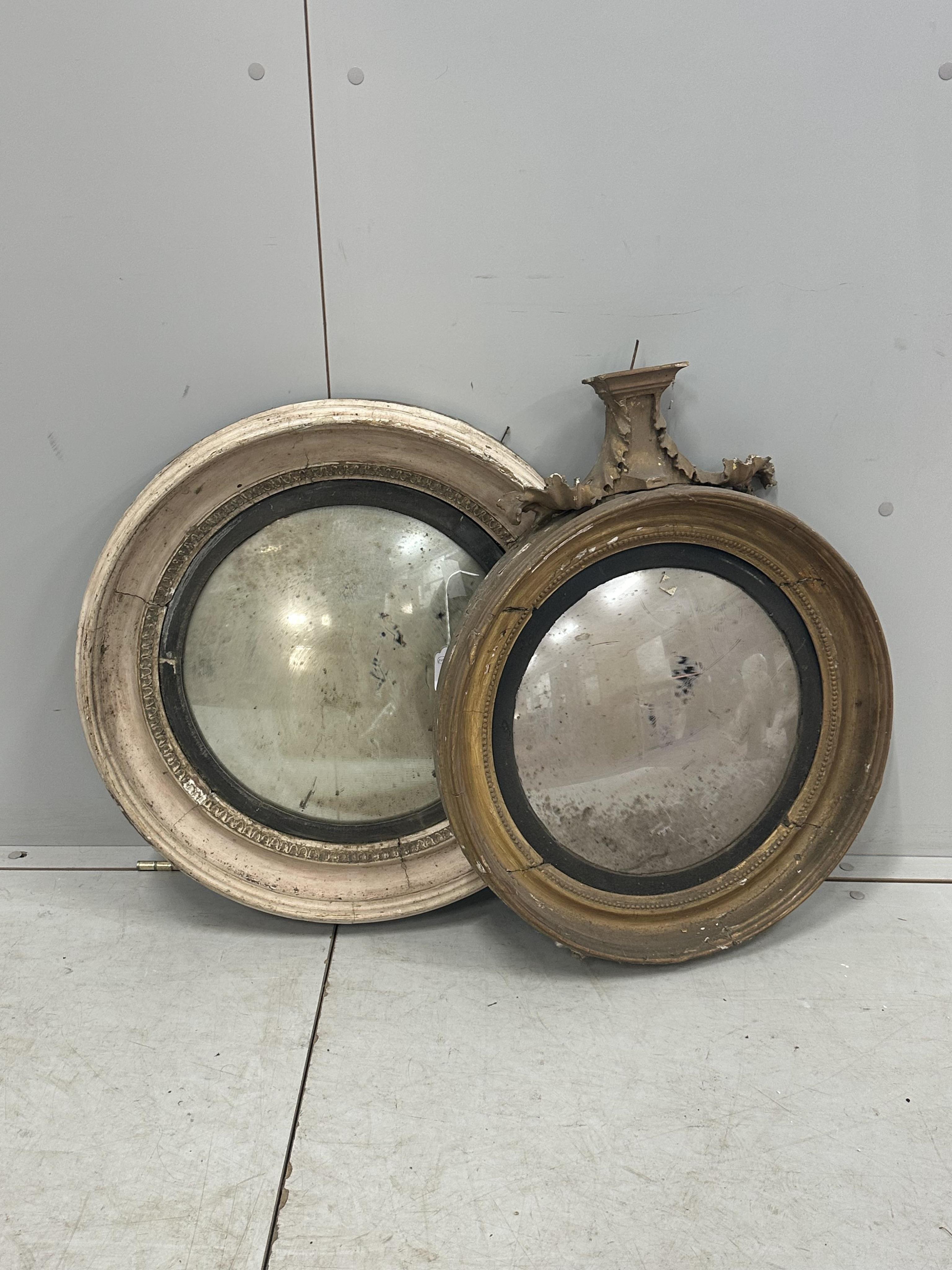 Two Regency circular convex wall mirrors, larger diameter 58cm together with two carved eagle surmounts. Condition - poor